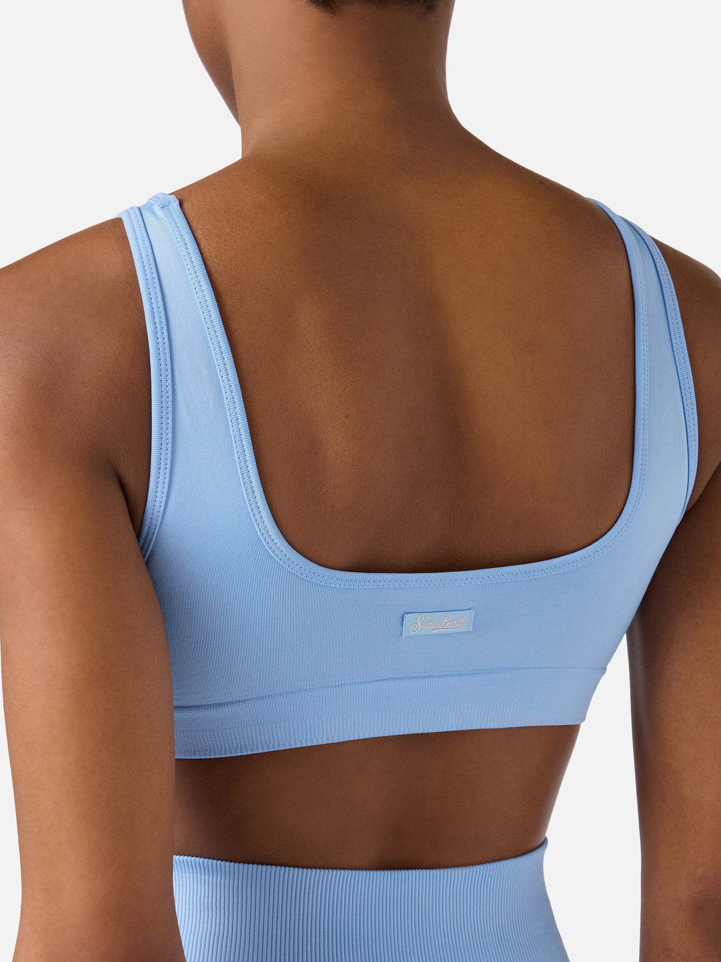 Top sportivo Fify azzurro in tessuto tecnico con profili a contrasto