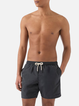 Patmos swim shorts in black with used effect and logo embroidery