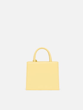 Structured Shop mini bag in butter yellow smooth leather with metal tag